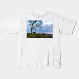 Cannon under naked tree on a hill Kids T-Shirt